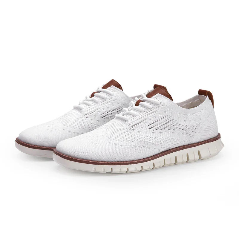White knit casual shoes with brown leather accents and flexible white soles on white background