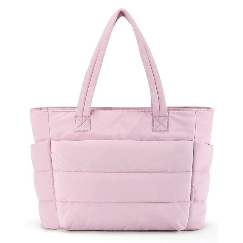Light pink quilted tote bag with dual top handles and spacious exterior pockets