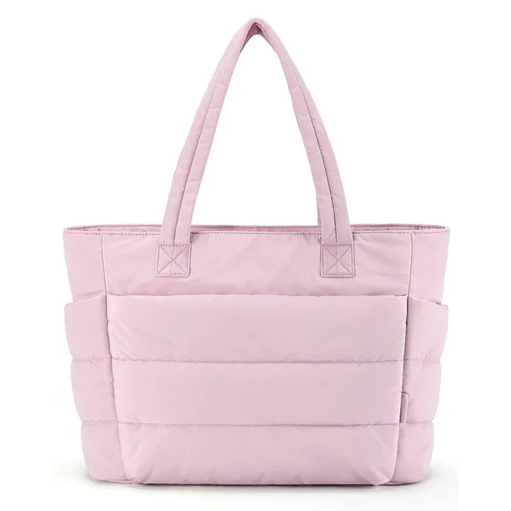 Light pink quilted tote bag with dual top handles and spacious exterior pockets