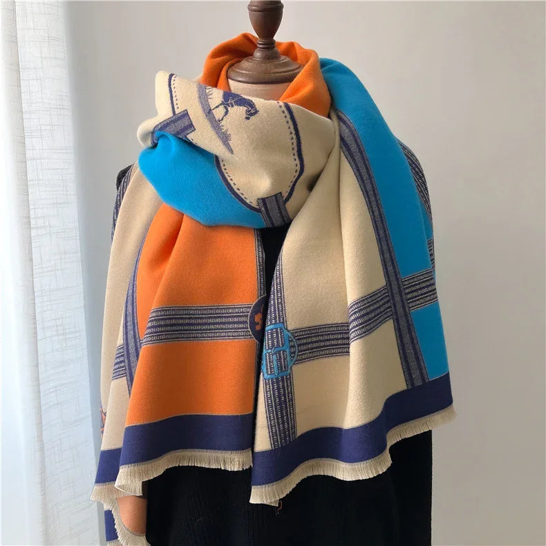 Wool scarf with orange, blue, and cream color blocks featuring stitched patterns on a dress form