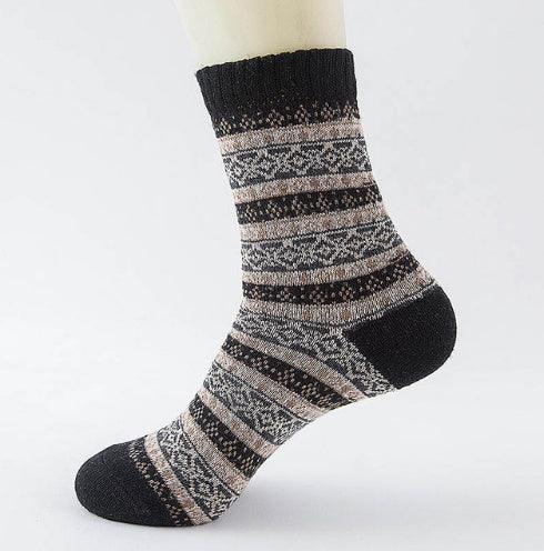 Black and beige knit patterned crew sock with ribbed cuff on mannequin foot