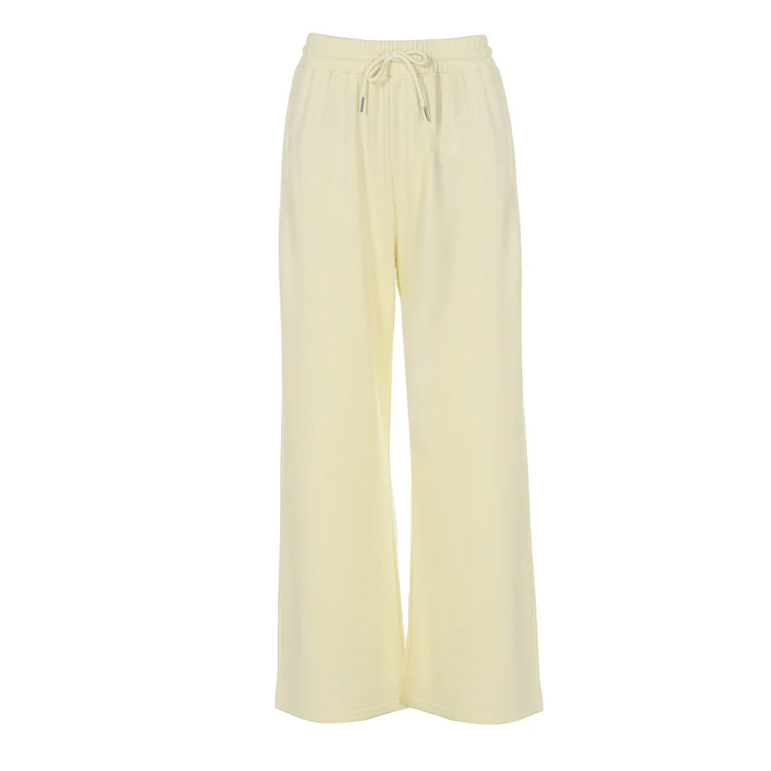 Cream wide-leg lounge pants with elastic waistband and drawstring against white background