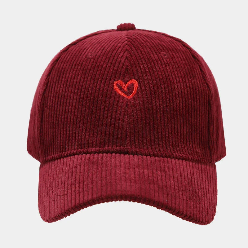 Burgundy corduroy baseball cap with small red embroidered heart on front