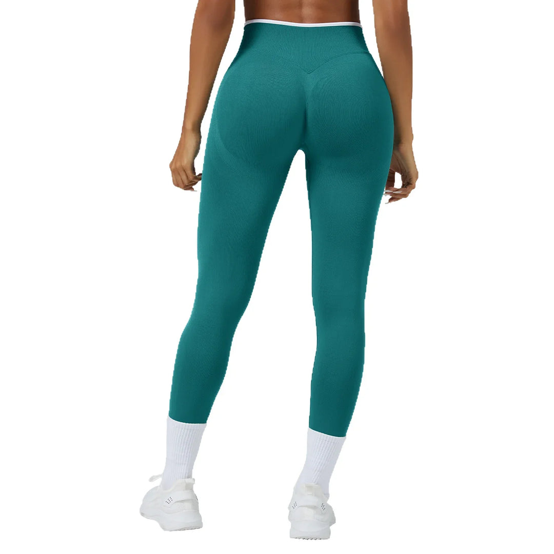 Woman from back wearing teal seamless high-waisted leggings with white sneakers and socks