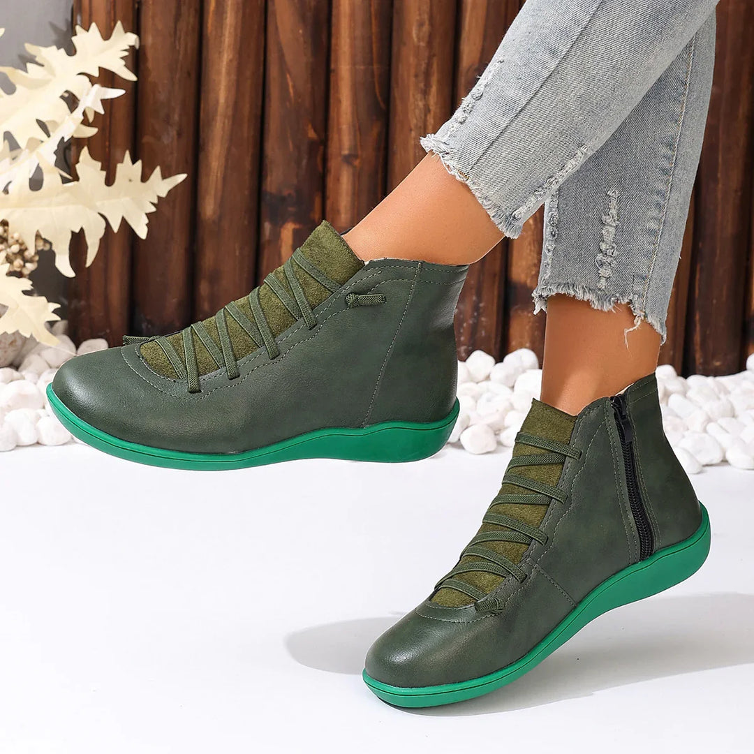 Stylish green leather ankle boots with side zipper and laces worn with frayed light denim jeans
