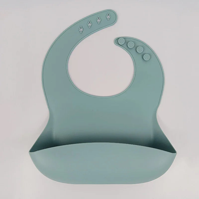 Blue silicone baby bib with adjustable snap buttons and food crumb catcher