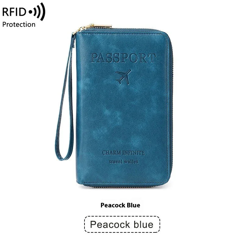 Peacock blue RFID protected travel wallet with wrist strap and embossed passport design