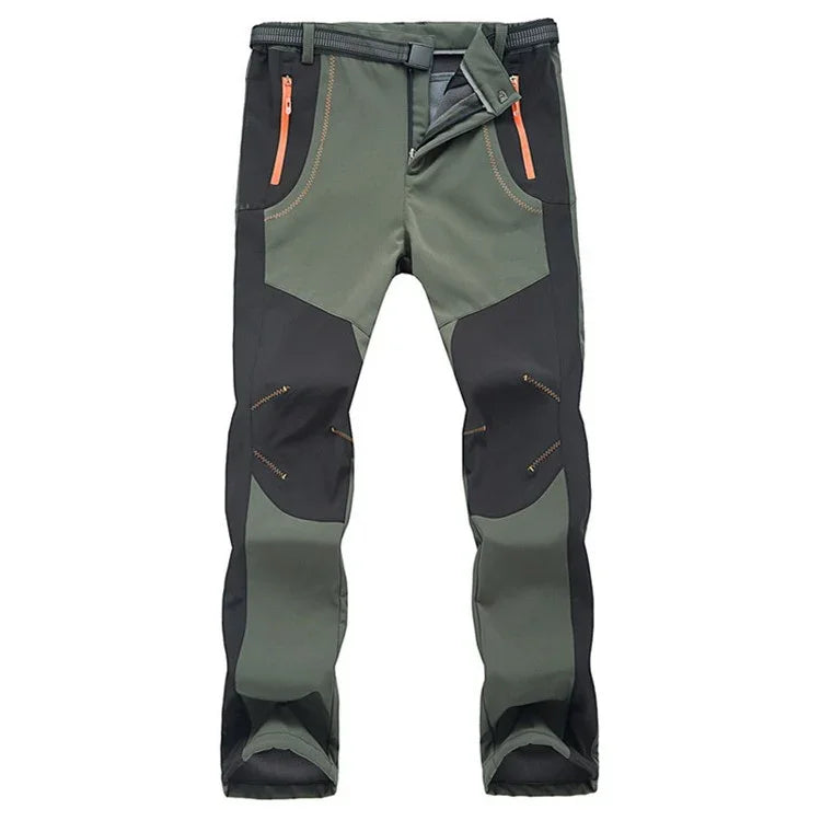 Men's durable outdoor hiking pants with reinforced black and green fabric and zippered pockets