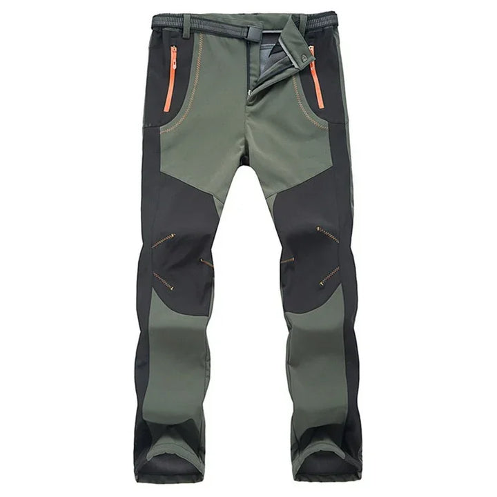 Men's durable outdoor hiking pants with reinforced black and green fabric and zippered pockets