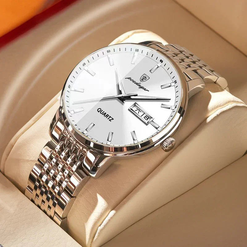 Silver quartz wristwatch with white dial and date display on a beige cushion