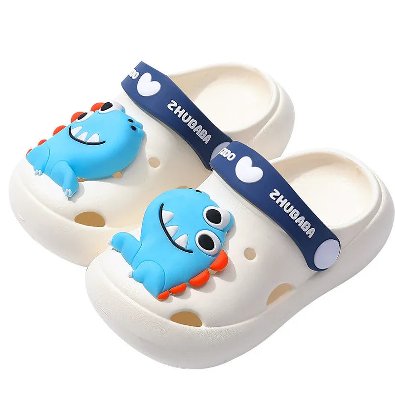 White kids clogs with blue dinosaur decoration and navy blue adjustable heel strap with heart and text