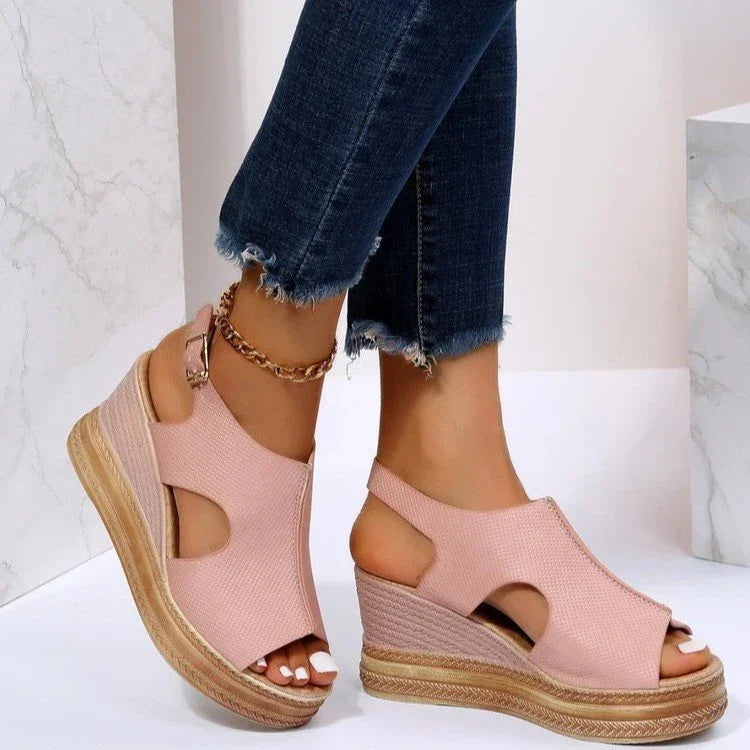 Wedge espadrille sandals in blush pink with cutouts, worn with frayed hem dark blue jeans and ankle chain