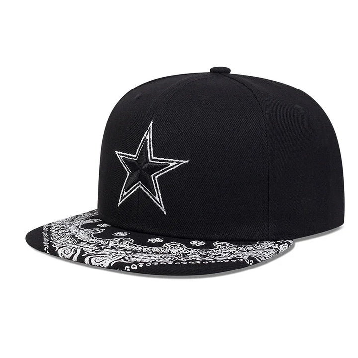 Black snapback cap with white embroidered star and a black and white paisley patterned flat brim