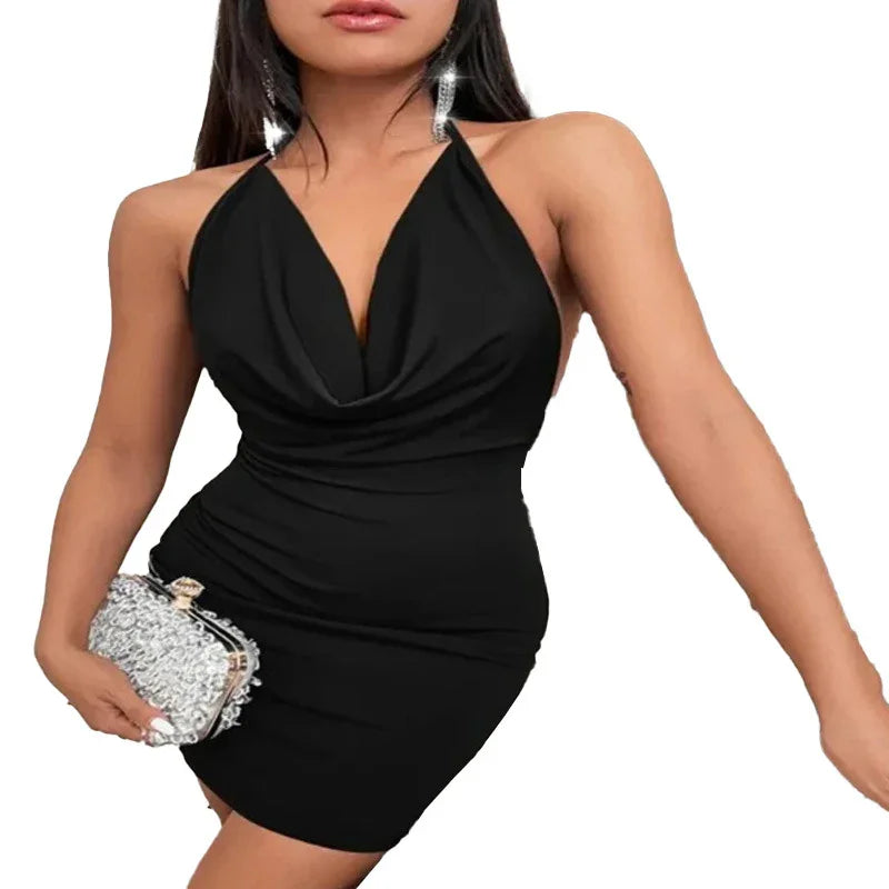 woman wearing black halter neck bodycon mini dress holding silver embellished clutch