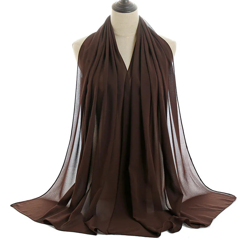 Dark brown lightweight chiffon scarf draped on mannequin against white background