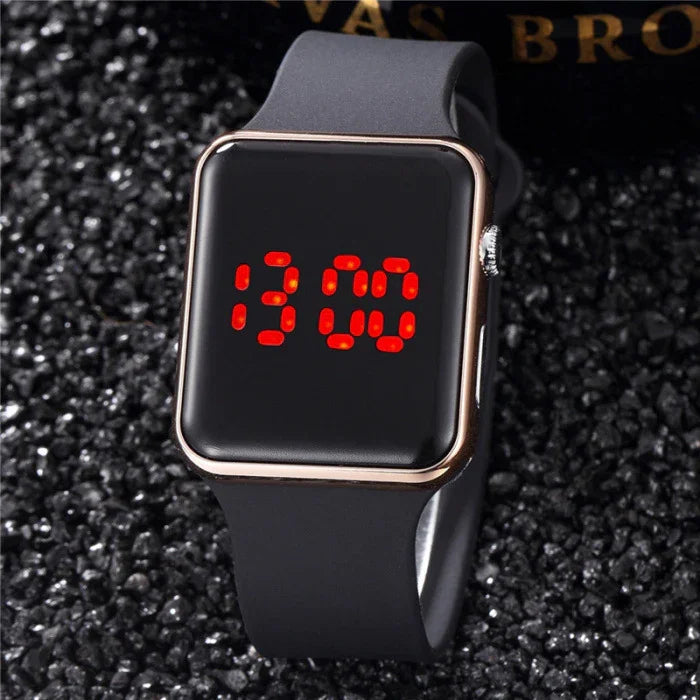 Black digital wristwatch with red LED display showing 13:00 on glittery black surface