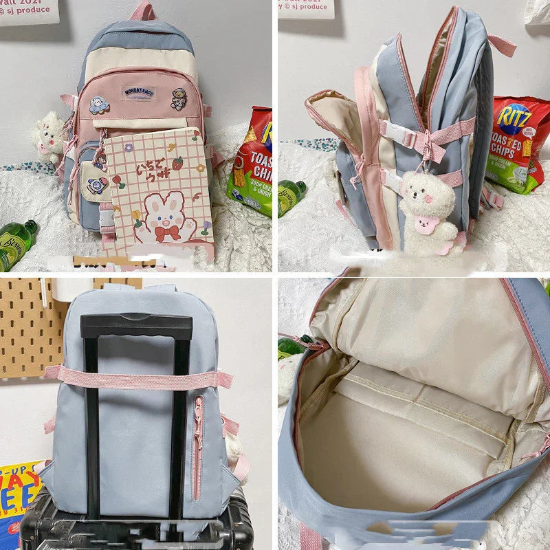 Pink and blue backpack with cartoon patches, plush keychain, open compartment, and attached to suitcase handle