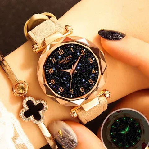 Elegant women's wristwatch with starry black dial and rose gold bezel on beige leather strap