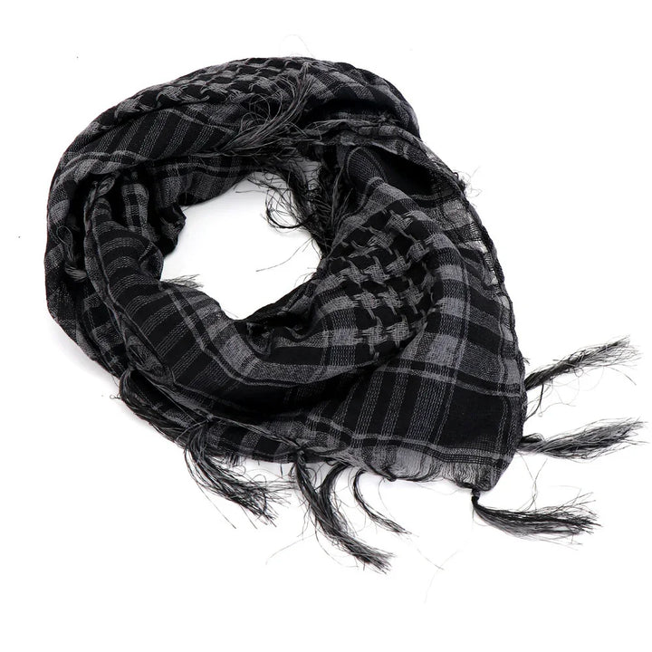 Black and gray patterned keffiyeh scarf with fringed edges on white background