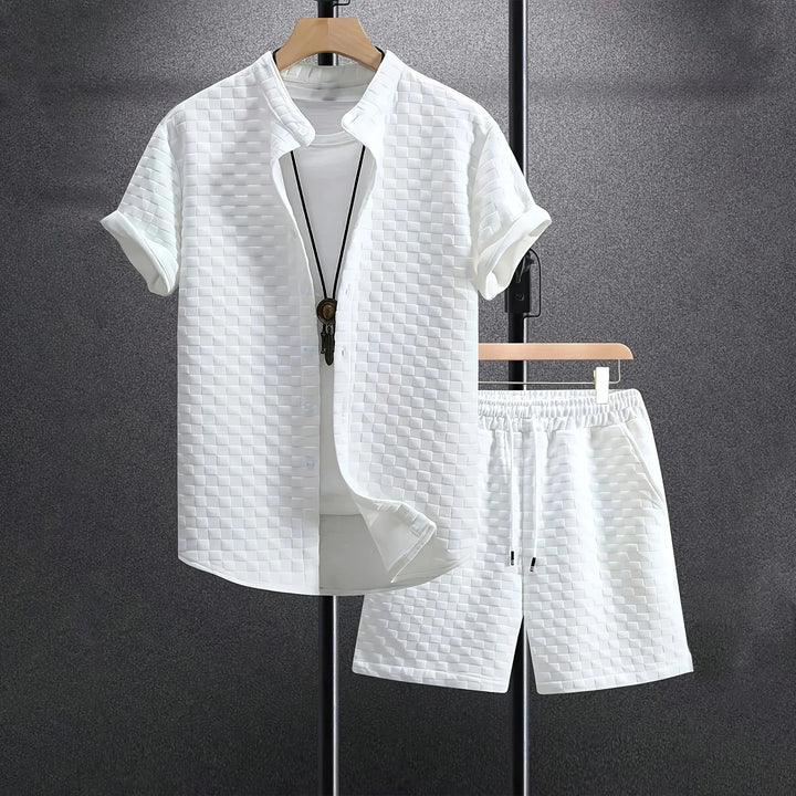 White men's short-sleeve checkered shirt and matching shorts set on black stand