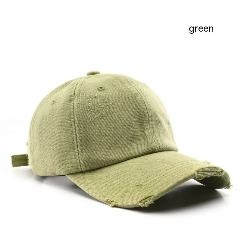 Green distressed cotton baseball cap with curved brim on white background