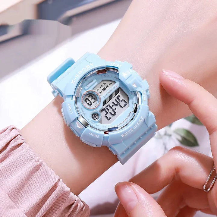 Close-up of wrist wearing light blue digital K-Sport water-resistant sports watch with mode and light buttons