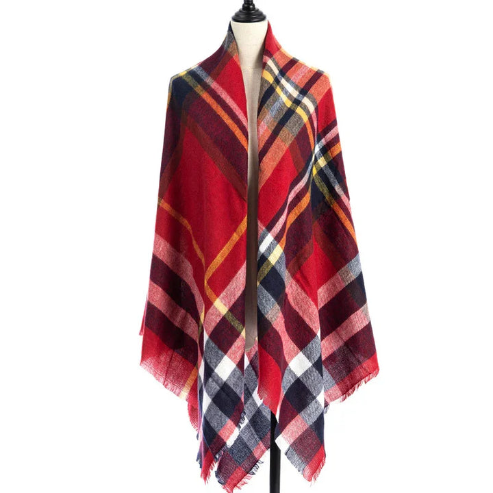 Red plaid shawl with multicolor check pattern draped on mannequin against white background