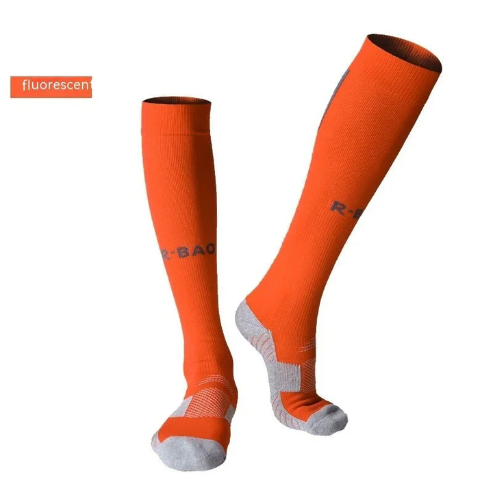 Fluorescent orange knee-high sports socks with gray accents on white background