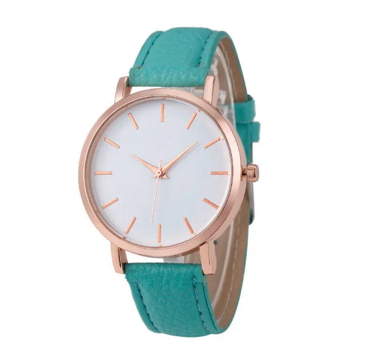 Rose gold wristwatch with white dial and aqua blue leather strap on white background