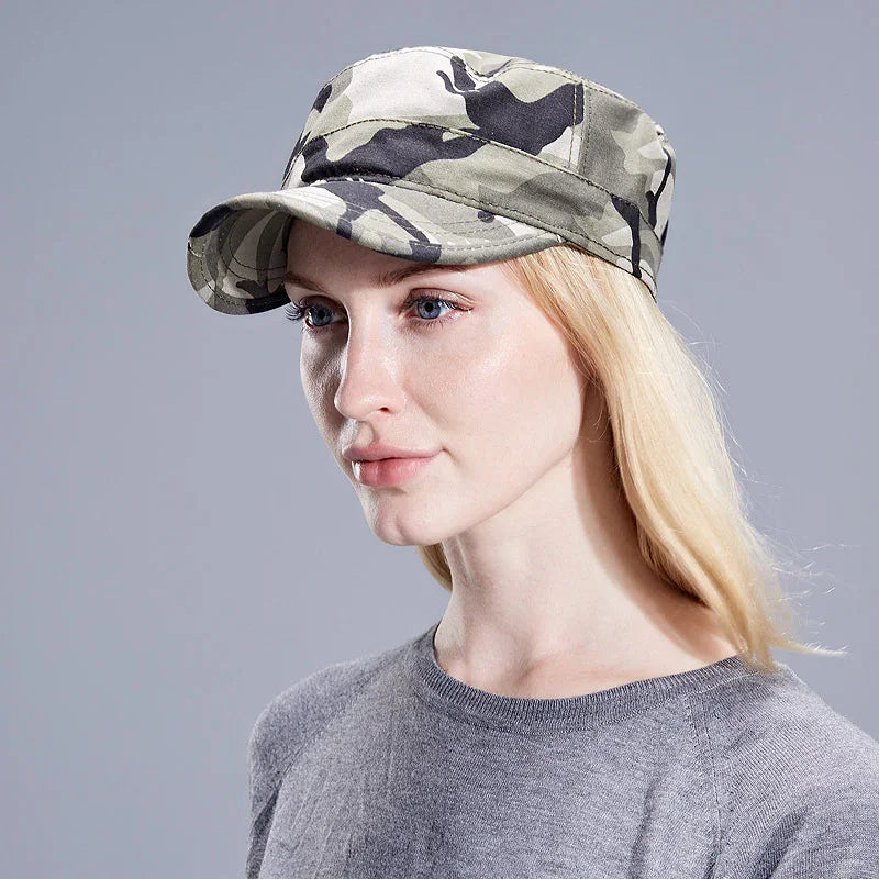 Blonde woman wearing gray camouflage military cap and gray sweater on gray background