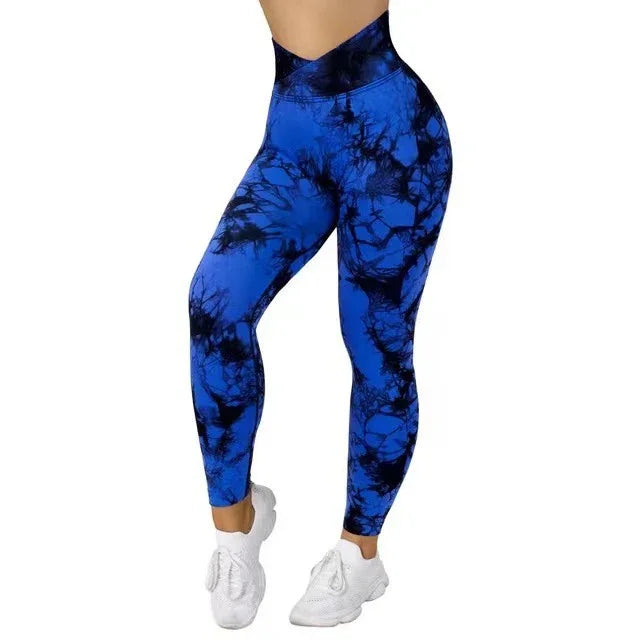 Woman wearing blue and black tie-dye high-waisted leggings with white sneakers