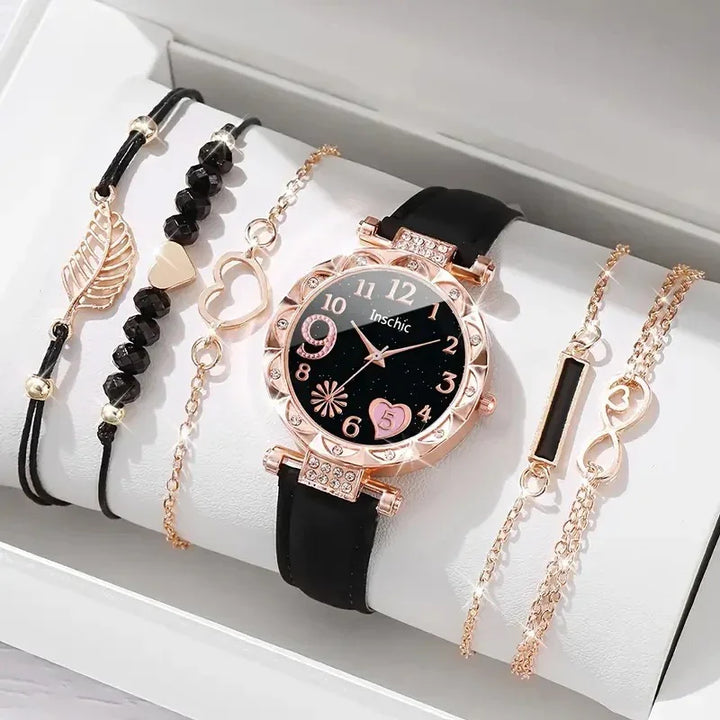 Black and rose gold wristwatch with decorative bracelets featuring hearts, beads, and infinity charms in a gift box