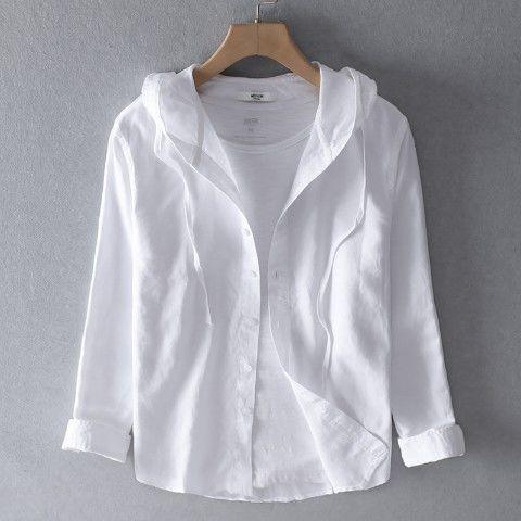 White casual button-up shirt with hood and rolled sleeves on wooden hanger against gray background