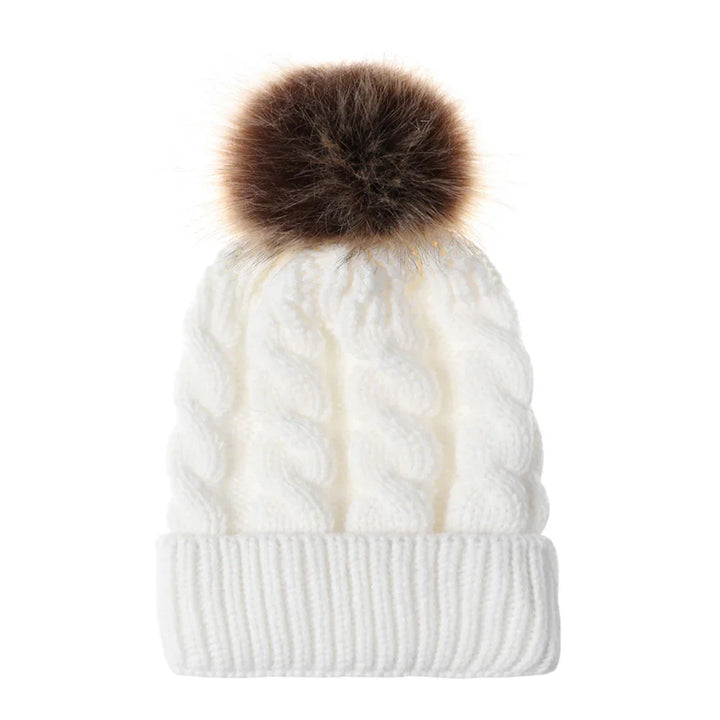 White knitted winter beanie hat with cable pattern and large brown pom pom