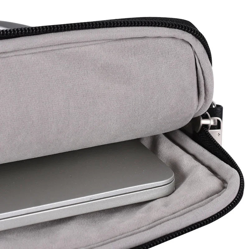 Close-up of silver laptop inside soft grey padded zippered case