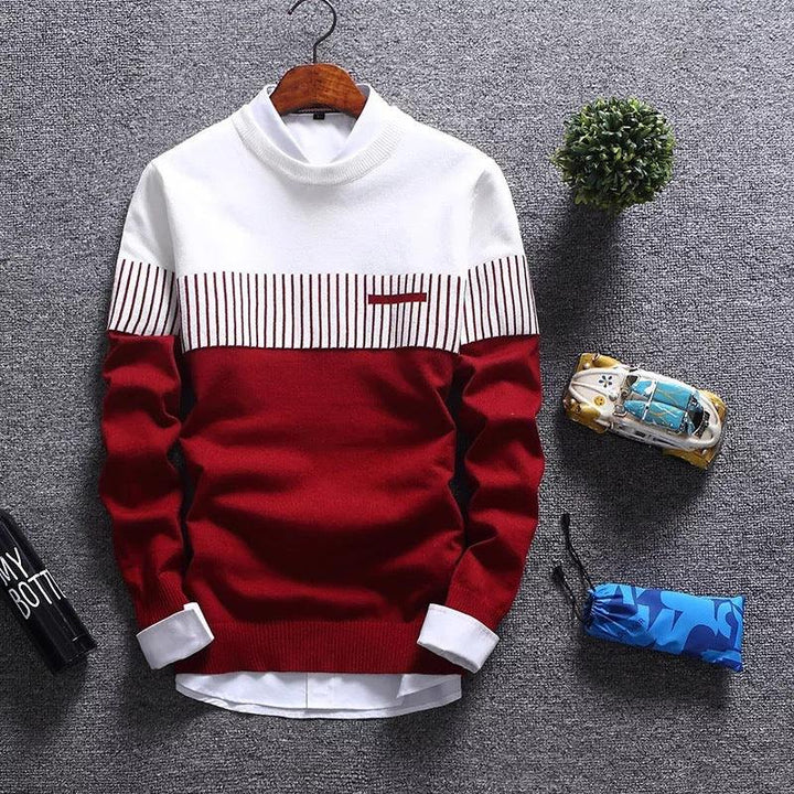 Red and white striped men's sweater on wooden hanger with folded white shirt underneath on gray carpet