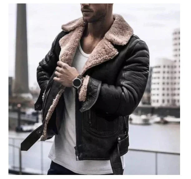 Man wearing black leather shearling jacket with beige fur collar over white t-shirt by waterfront