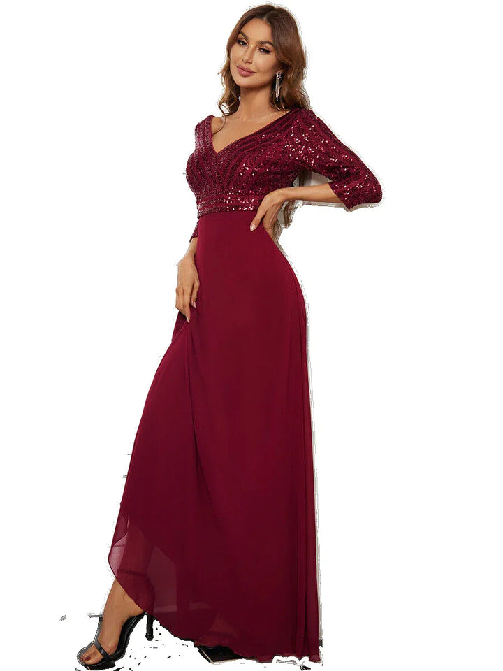 Elegant woman wearing a floor-length burgundy evening gown with sequined bodice and 3/4 sleeves