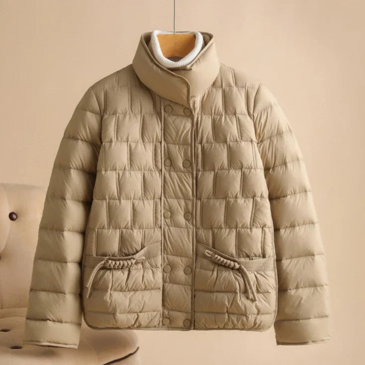 Beige quilted puffer jacket with high collar and button closure, padded winter coat style
