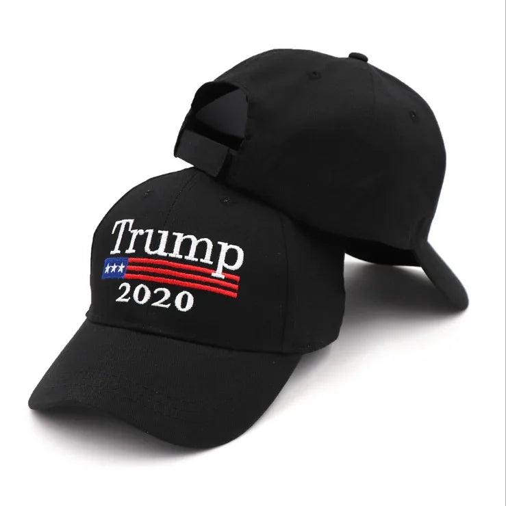 Black baseball caps featuring embroidered Trump 2020 text with patriotic stars and stripes design