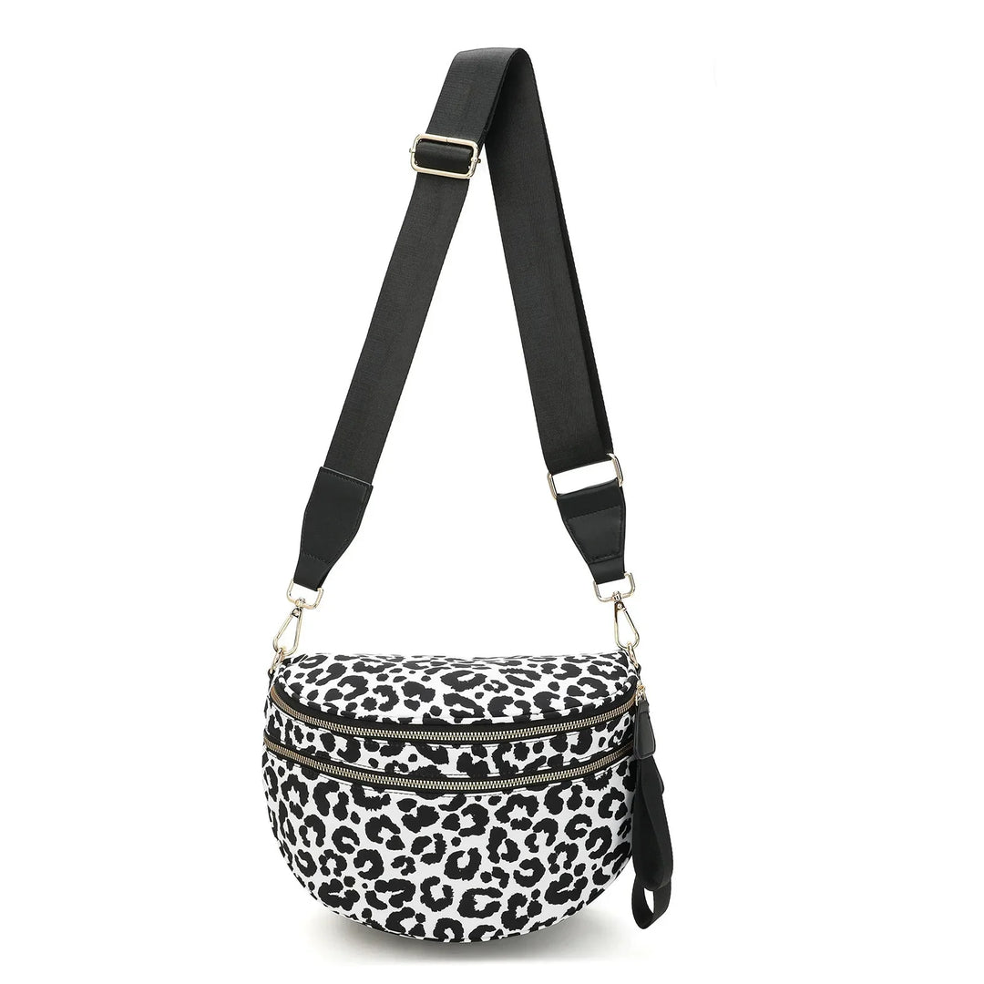 Black and white leopard print crossbody bag with two zippered compartments and adjustable black strap