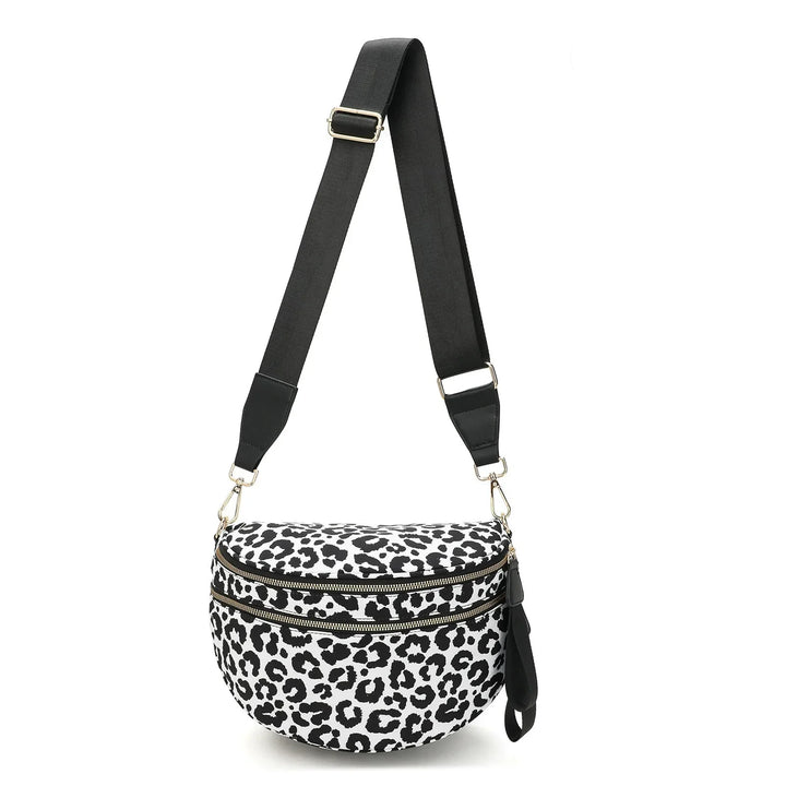 Black and white leopard print crossbody bag with two zippered compartments and adjustable black strap