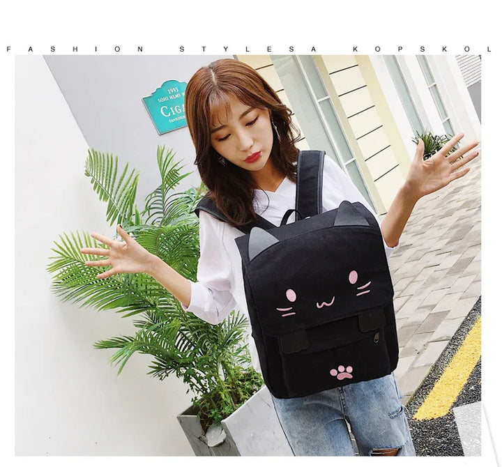 Young woman wearing casual white shirt and jeans with black cat face backpack outdoors near green plants