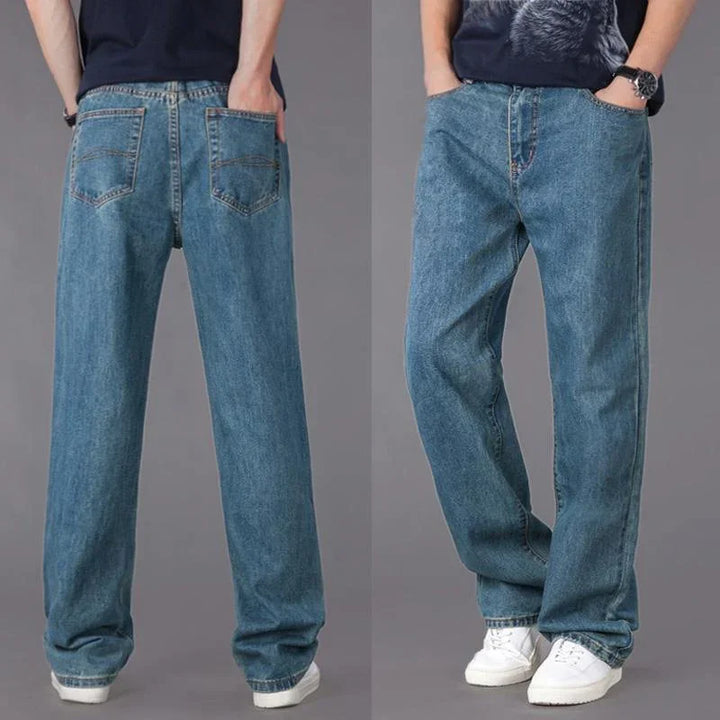 Front and back views of a person wearing loose-fit blue denim jeans and white sneakers