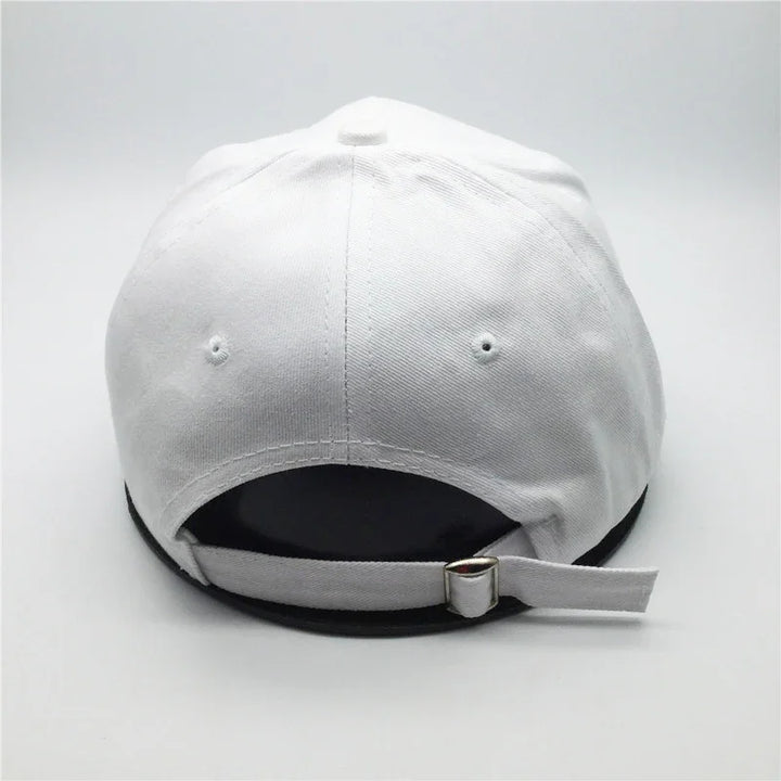 White adjustable baseball cap with metal buckle and ventilation eyelets shown from back