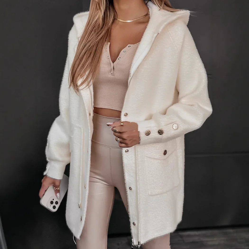 Woman wearing beige crop top, high-waisted leggings, and white button-up fuzzy jacket with hood