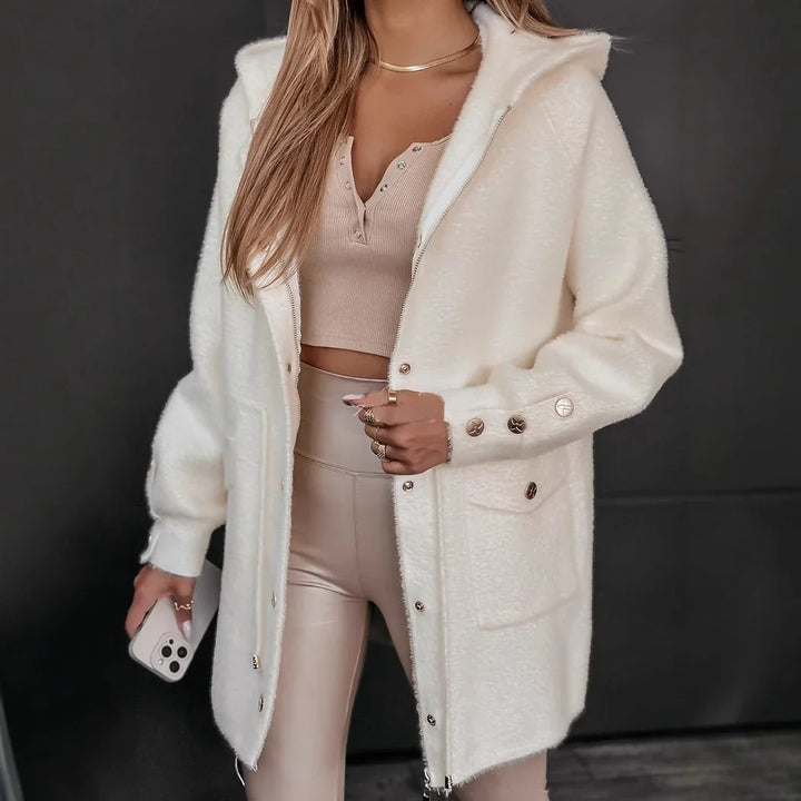 Woman wearing beige crop top, high-waisted leggings, and white button-up fuzzy jacket with hood