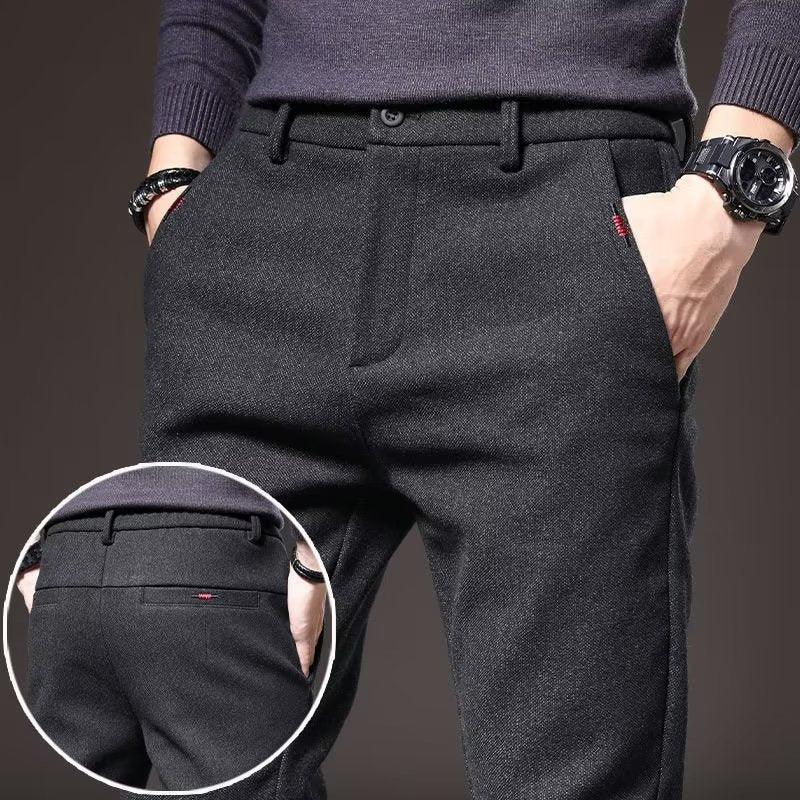 Men's dark gray wool blend dress pants with front and back pockets, worn with a dark sweater and watch