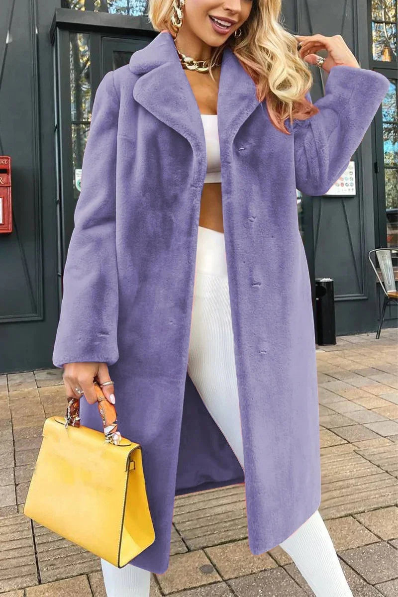 Fashionable woman in a long purple faux fur coat holding a yellow handbag outdoors