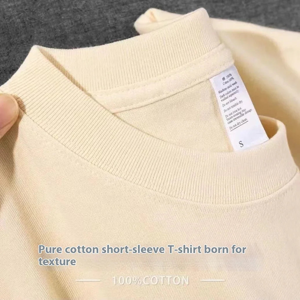Close-up of beige 100% cotton short-sleeve T-shirt collar with fabric care label